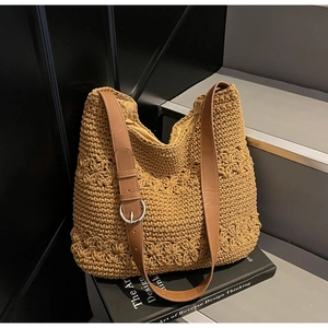 Close-up of bohemian woven hobo bag showing floral crochet texture and leather strap
