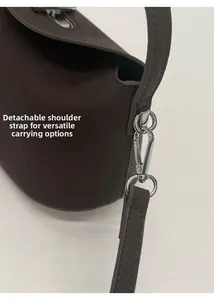 Detail of dark brown lychee grain leather bag with silver metal hooks for strap