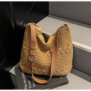 Detailed close-up of handmade crochet tote bag featuring 3D floral patterns and leather strap