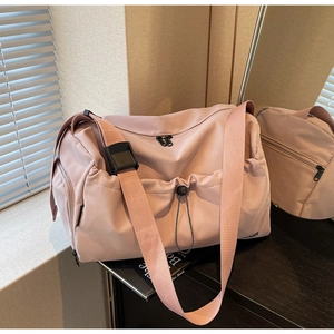Detail view of pink waterproof travel bag with multiple pockets and durable straps