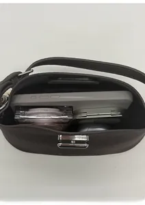 Interior view showing the capacity of a dark brown pebble leather handbag with silver buckle