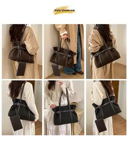 Styling display of large suede tote bags in dark brown and black with metal buckles
