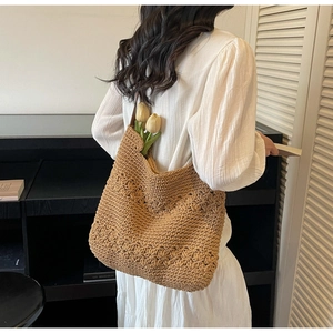 Detail of hand-woven crochet tote bag with flower pattern for summer beach vacations