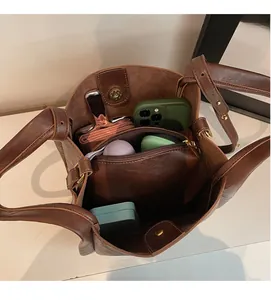 Interior view of brown leather bucket bag showing large capacity and zipper pocket