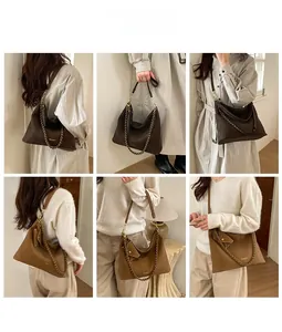 Detail showing two leather hobo bags with metal chains and detachable coin purses