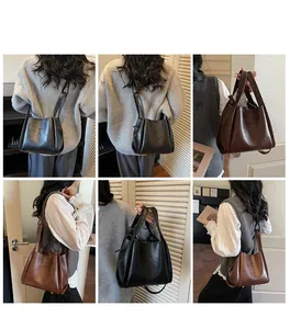 Minimalistische Beuteltasche aus PU-Leder am Modell in Schwarz und Braun