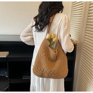 Detail of bohemian brown crochet tote bag showing thick knit texture and leather strap