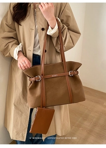 Brown retro tote bag with minimalist logo and matching small pouch on a stylish model