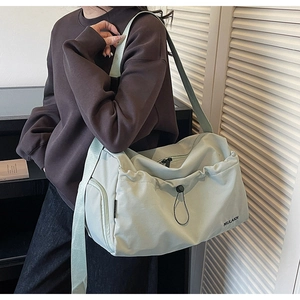 Mint green gym bag shown with adjustable strap in a casual lifestyle setting