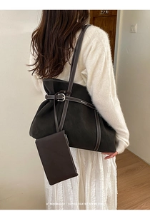 Detail of dark brown tote bag with white contrast stitching and matching mini pouch