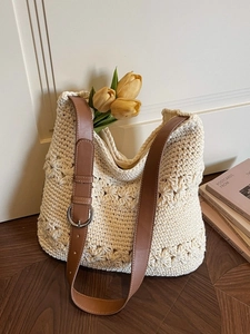 Handcrafted cream woven tote bag with adjustable brown leather straps for beach vacation