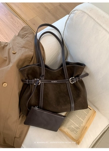 Detailed view of brown faux suede tote bag set with branded buckle and small pouch