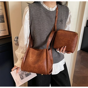 Brown PU leather bucket bag set shown on model in a stylish indoor lifestyle setting