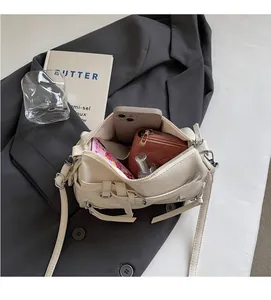 Top view of spacious interior of cream leather bag with smartphone and wallet