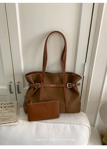 Detailed shot of caramel brown tote bag set with metal buckle and small inner pouch