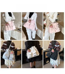 Detail view of large tote bag with front pockets and cute bear charm in four colors