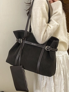Deep brown large tote bag with contrast white stitching and decorative silver buckles