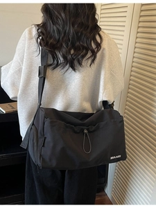 Large black travel bag with shoulder strap and wet-dry separation for fitness use