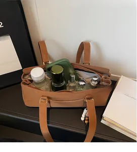 Detail view of the spacious interior of a brown vintage Boston bag with daily essentials