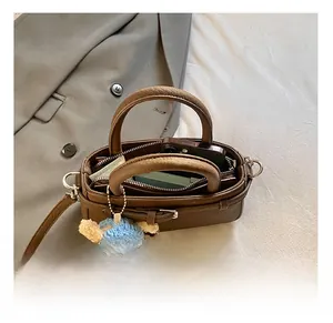 Detailed interior of a brown pebbled leather crossbody bag showing large phone capacity