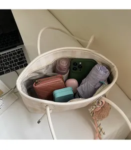 Top view of white textured tote bag showing large interior space for daily essentials