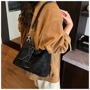 Detail of black matte suede hobo bag with gold logo and matching mini envelope pouch