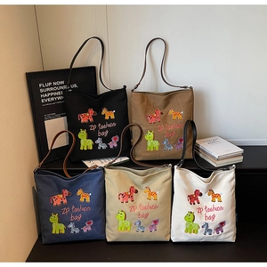 Detail of colorful cartoon horse embroidery on large canvas tote bags in five colors