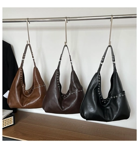 Detailed view of hobo bags in black, dark coffee and brown with silver grommet accents