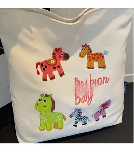 Detail of cute animal embroidery and red fashion bag text on beige canvas tote