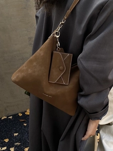 Brown suede tote bag with small envelope pouch and gold metal logo in autumn style