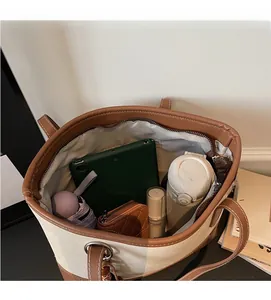 Spacious interior of a contrast color tote bag holding an iPad, umbrella, and wallet