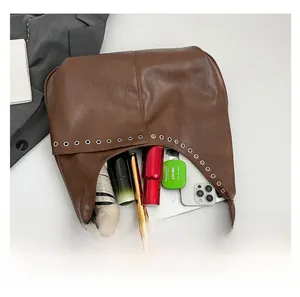 Internal view of brown hobo bag showing large capacity for umbrella and cosmetics