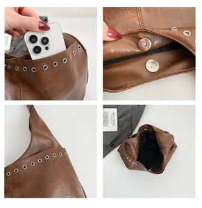 Detail of dark brown tote bag with metal eyelets and magnetic closure interior view