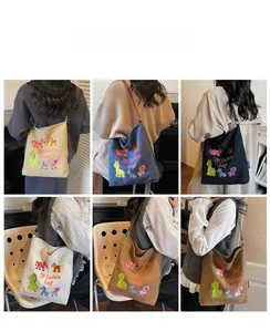 Detailed views of cartoon embroidered canvas tote bags with leather shoulder straps