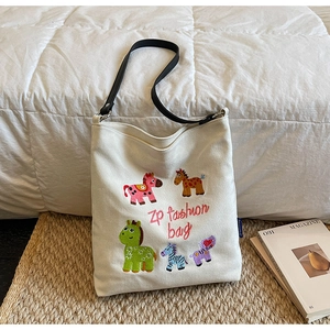 Detailed view of colorful cartoon horse embroidery and knit texture on canvas tote bag