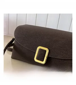 Detail showing deep brown lychee texture leather and a golden rectangular buckle closure