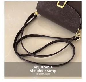 Detail showing the adjustable leather strap and gold buckle on a brown shoulder bag