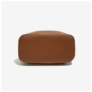 Detail view of the brown leather bucket bag bottom with fine stitching and matte finish