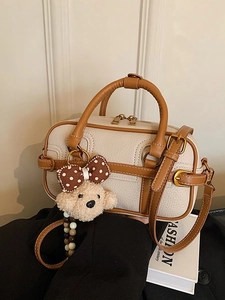 Chic beige lychee leather boston bag with brown trim and cute teddy bear pendant charm