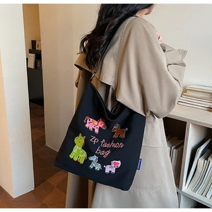 Detail of cute animal embroidery and Zp fashion bag logo on black canvas tote bag