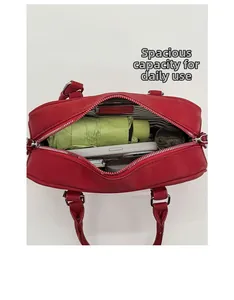Internal view showing large capacity for umbrella, phone, and makeup in red handbag