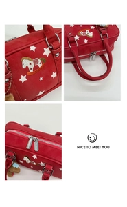 Macro view of red retro pillow bag featuring white star prints and rocking horse embroidery
