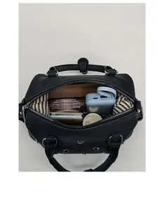Internal view of black vintage boston bag showing spacious capacity for daily items