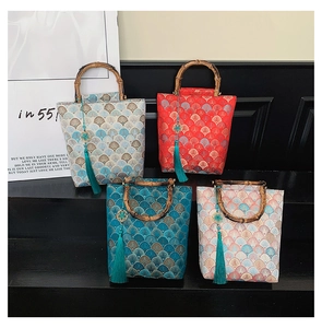 Close-up of four-color Chinese brocade handbags with bamboo handles and long tassels