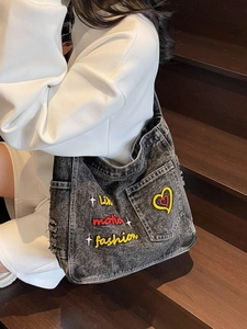 Distressed grey denim tote bag with colorful embroidery and trendy utility pockets