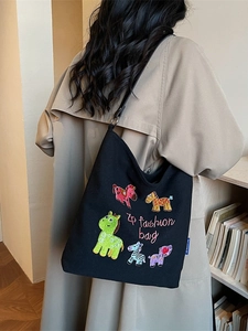 Black canvas tote bag with colorful cartoon horse embroidery and pink fashion lettering