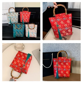Close-up of Chinese style embroidery bags with bamboo handles and silk tassels detail