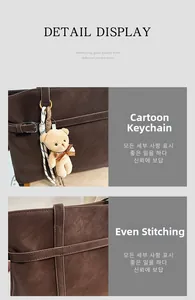 Detail of dark brown leather tote featuring precise stitching and metal D-ring hook