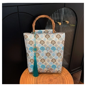 Detail of Chinese style jacquard tote with bamboo handle and elegant tassel ornament