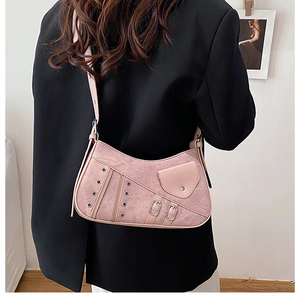 Detailed back view of pink Y2K hobo bag with eyelets and metal zippers worn by a model
